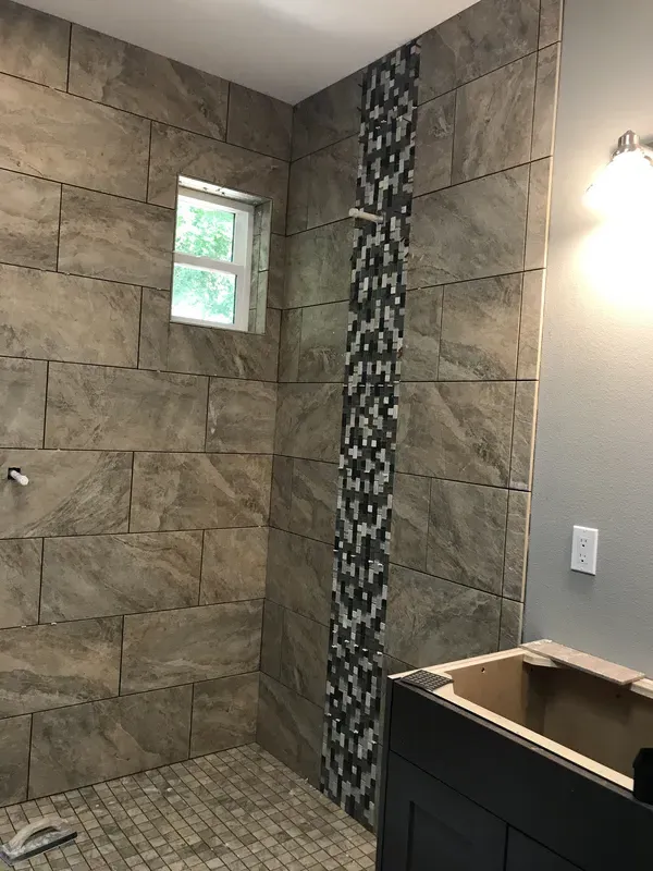 Unique gray tile pattern with waterfall effect walk in shower