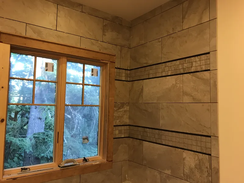 Closeup of tiling in updated shower with a window