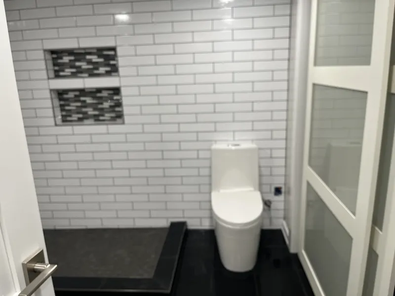 Alternate angle of the updated bathroom with tile walls