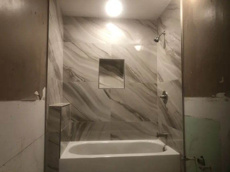 Marble style tile shower with tub