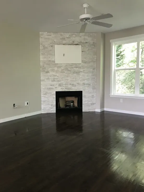 White stone fireplace with TV insert spot