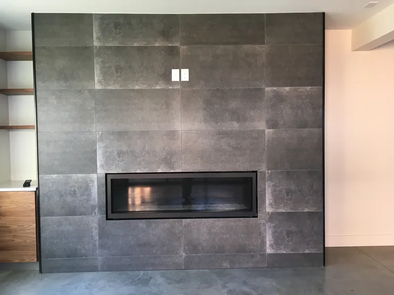 Dark modern stone fireplace with gas insert